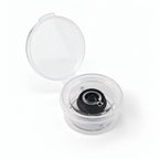 Small black elastic invisible thread spool in an open storage case